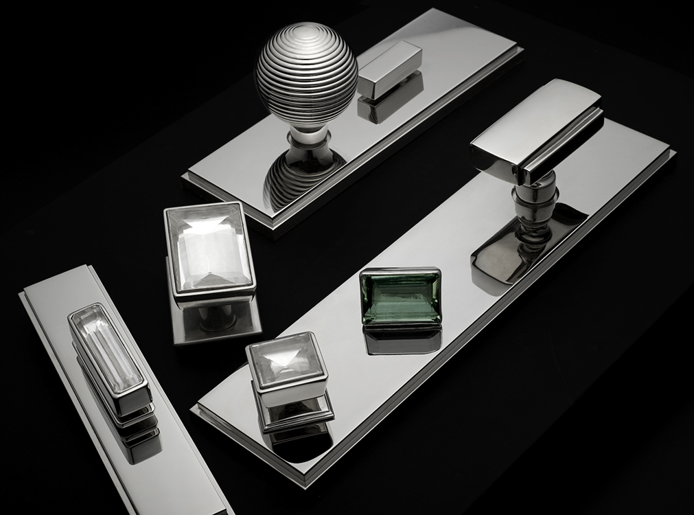 Ensemble of modern hardware in polished nickel and custom rock cystal pulls.